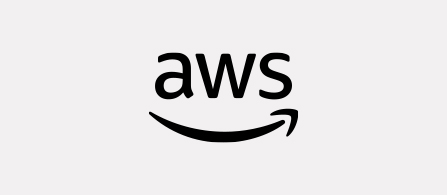 The AWS logo on a light gray background. Black lowercase letters spell “aws” with a curved orange arrow beneath them, shaped like an upward smile.