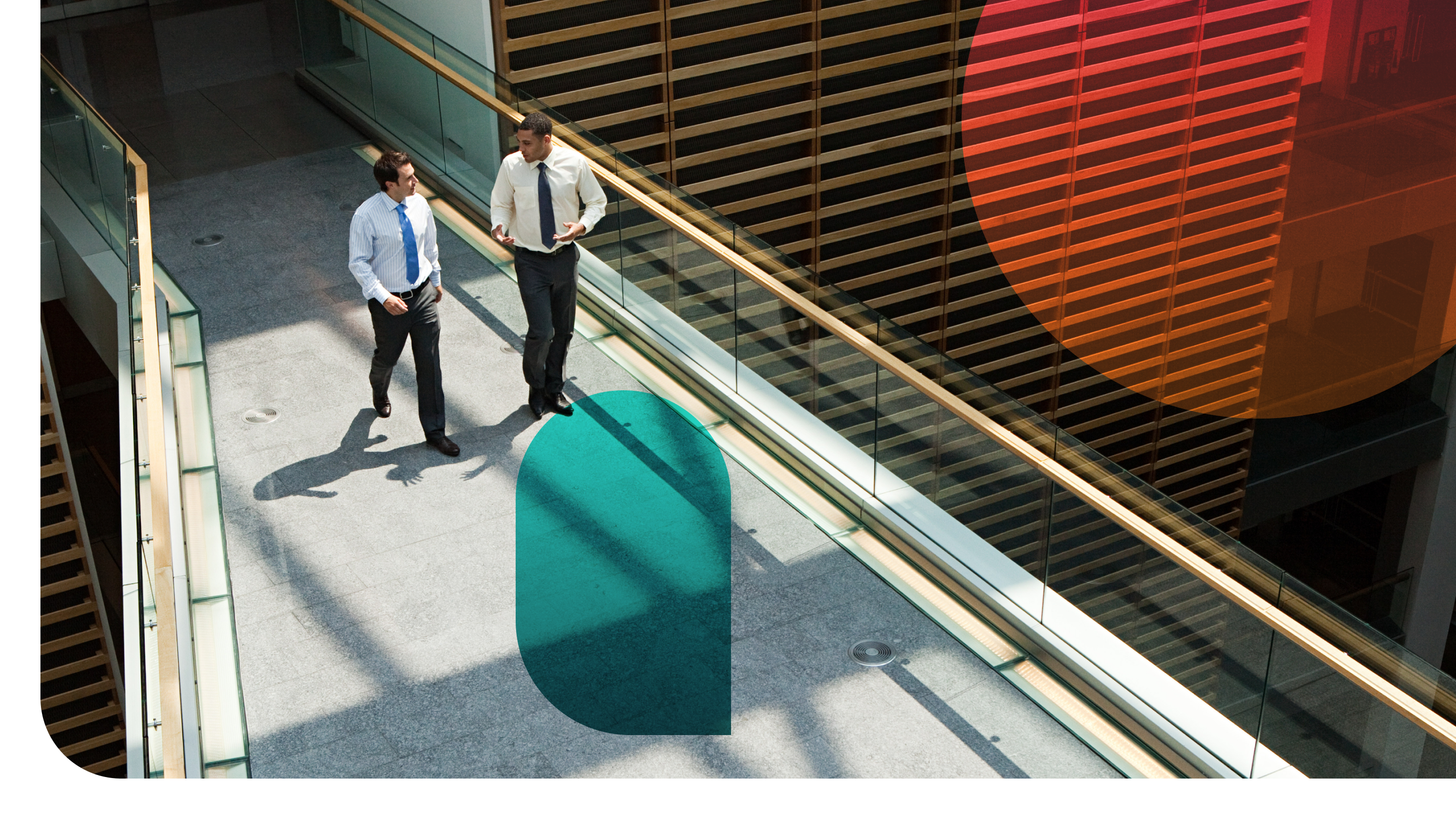 Two professionals having an animated discussion on an elevated walkway.