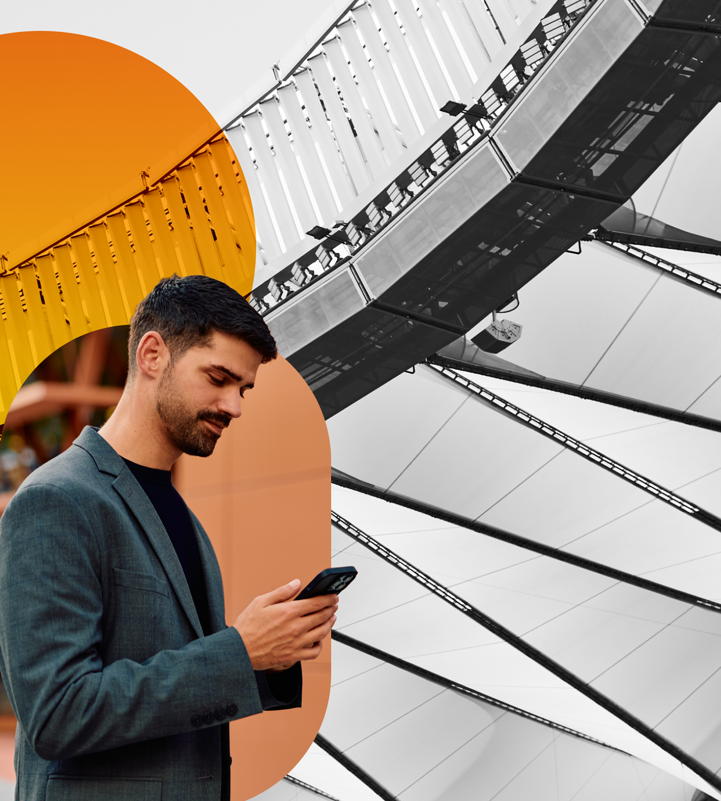 A man looking at his phone and smiling against a graphic background.